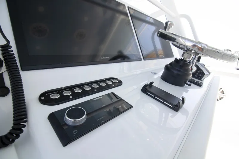 Slide: The Image of Control panel of 2026 Yellowfin 42 Offshore boat with steering wheel and electronic displays. - 29