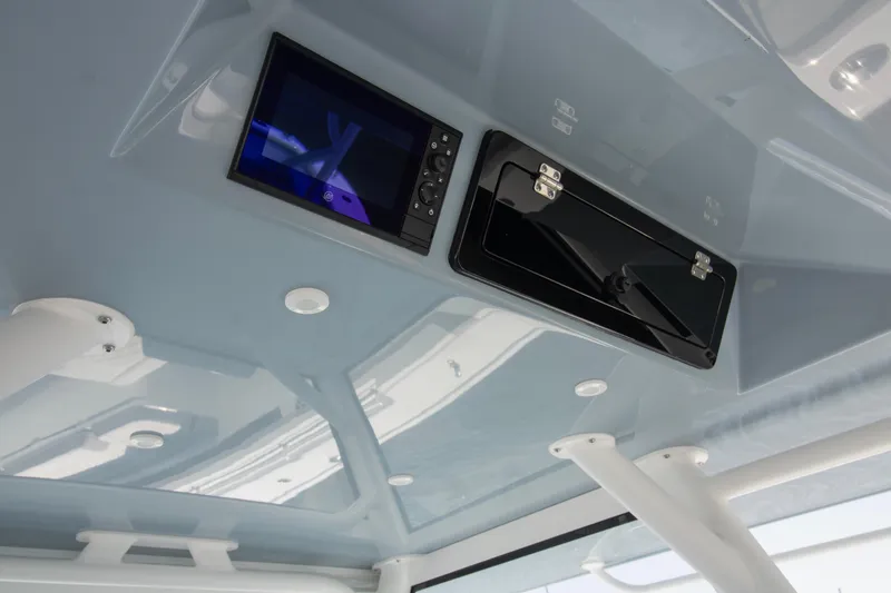 Slide: The Image of 2026 Yellowfin 42 Offshore boat interior ceiling with electronic display and storage compartment. - 30