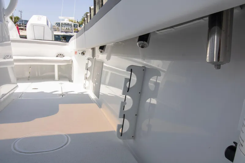 Slide: The Image of 2026 Yellowfin 42 Offshore boat interior with rod holders and seating. - 35