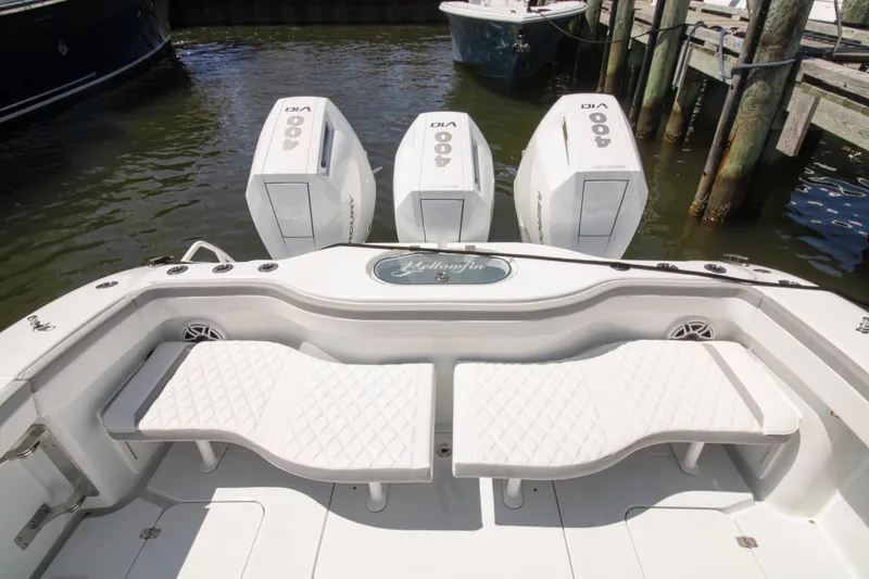 Slide: The Image of 2026 Yellowfin 42 Offshore boat with triple 400 horsepower engines, docked at marina. - 38