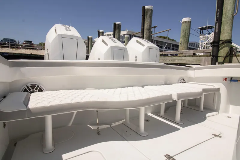 Slide: The Image of 2026 Yellowfin 42 Offshore boat with cushioned seating and powerful outboard engines. - 39