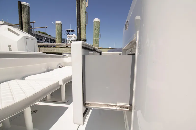 Slide: The Image of 2026 Yellowfin 42 Offshore boat interior with open storage compartment and seating. - 44