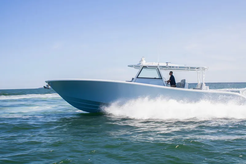 Slide: The Image of 2026 Yellowfin 42 Offshore boat cruising on open water under clear skies. - 6