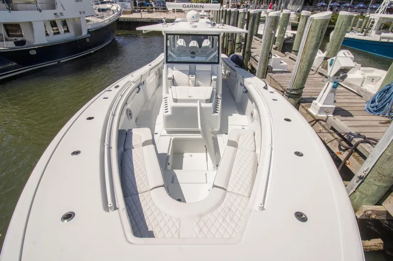Slide: The Image of 2026 Yellowfin 42 Offshore boat docked, featuring spacious seating and modern design. - 7