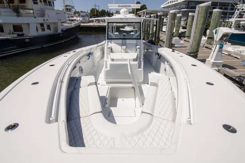 Slide: The Image of 2026 Yellowfin 42 Offshore boat with spacious seating at a marina dock. - 8