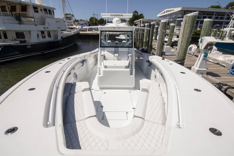 Slide: The Image of 2026 Yellowfin 42 Offshore boat docked, featuring spacious seating and modern design. - 9