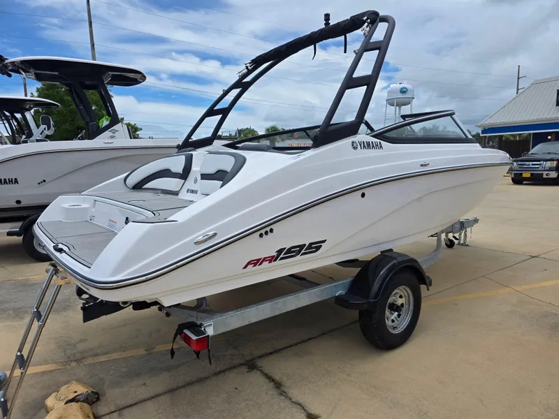 Slide: The Image of 2025 Yamaha Boats AR195 on trailer, sleek white design, outdoor display. - 4