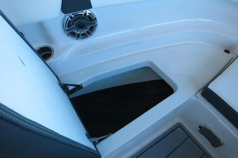 Slide: The Image of 2025 Chaparral 250 OSX boat interior with speaker and storage compartment. - 11
