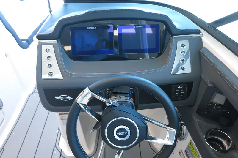 Slide: The Image of 2025 Chaparral 250 OSX dashboard with dual Simrad displays and modern steering wheel. - 17