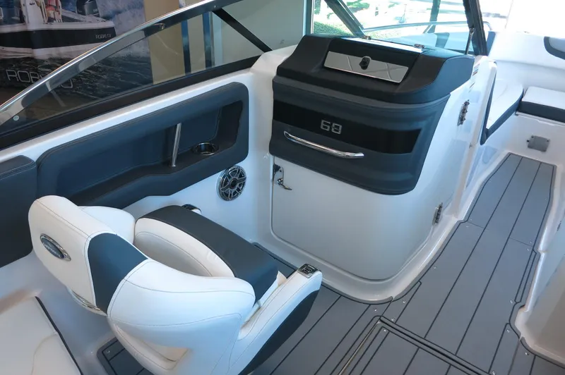 Slide: The Image of 2025 Chaparral 250 OSX boat interior with modern seating and sleek dashboard design. - 18