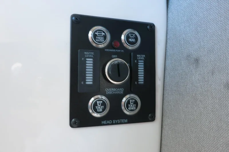 Slide: The Image of Control panel of 2025 Chaparral 250 OSX boat head system, showing waste and water levels. - 21