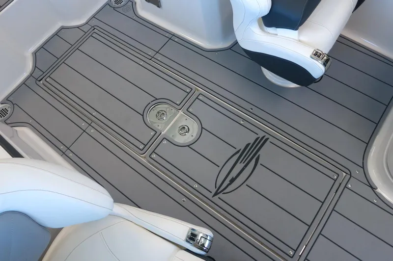 Slide: The Image of 2025 Chaparral 250 OSX boat interior with sleek gray flooring and white seating. - 22