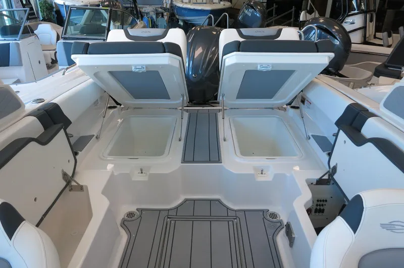 Slide: The Image of 2025 Chaparral 250 OSX boat interior with open storage compartments. - 30