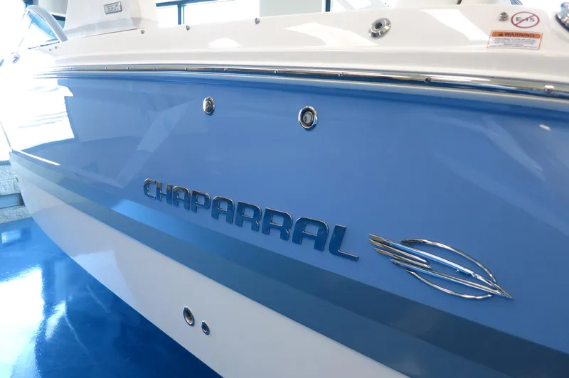 Slide: The Image of 2025 Chaparral 250 OSX boat with sleek blue and white design. - 4