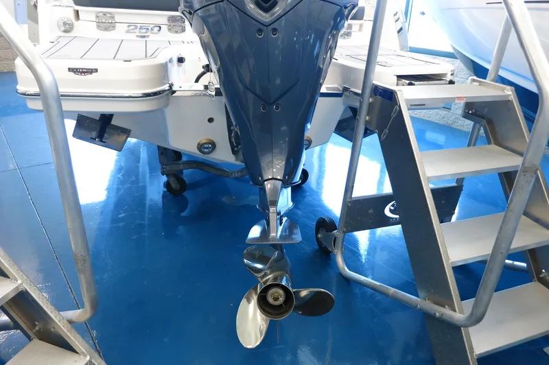 Slide: The Image of 2025 Chaparral 250 OSX boat with outboard motor and propeller in showroom. - 5