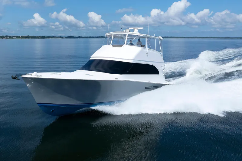 Slide: The Image of 2002 Post Convertible 56 yacht cruising on calm waters under a clear blue sky. - 11