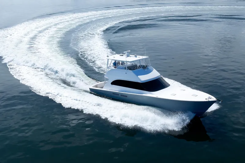 Slide: The Image of 2002 Post Convertible 56 yacht cruising on open water, creating a dynamic wake pattern. - 12