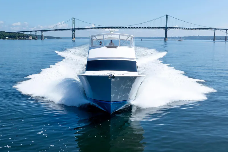 Slide: The Image of Luxury yacht cruising on calm waters near a bridge, 2002 Post Convertible 56. - 14