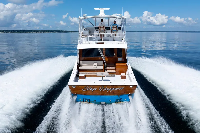 Slide: The Image of Luxury yacht "Ship Happens" cruising on calm waters, clear sky, rear view. - 15