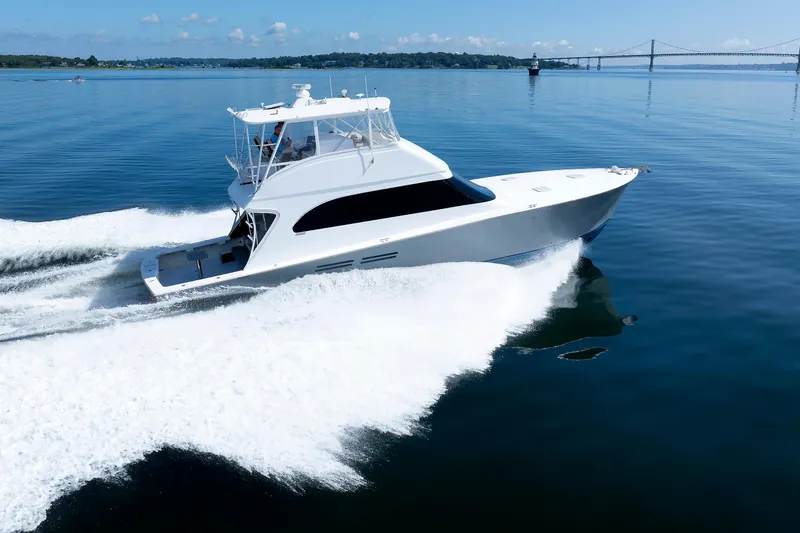 Slide: The Image of Luxury yacht cruising on calm waters near a bridge, clear sky, 2002 Post convertible 56. - 18