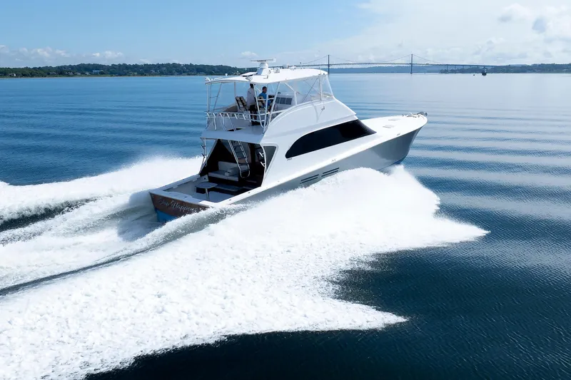 Slide: The Image of Luxury yacht cruising on calm waters, Post Convertible 56, 2002 model. - 19