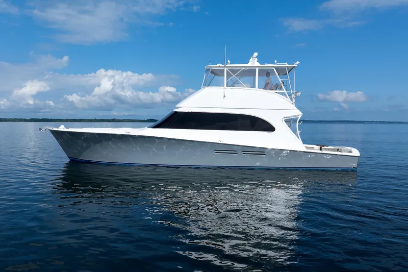 Slide: The Image of 2002 Post Convertible 56 yacht cruising on calm blue waters under a clear sky. - 2