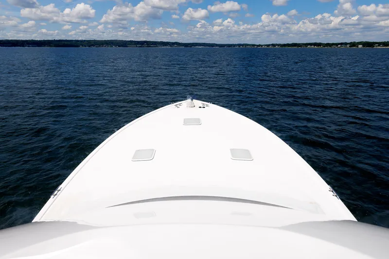 Slide: The Image of Bow of 2002 Post Convertible 56 yacht on open water under blue sky. - 22