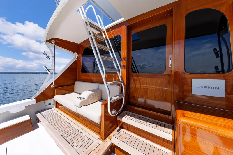 Slide: The Image of Luxurious 2002 Post Convertible 56 yacht deck with wooden finish and seating area. - 27