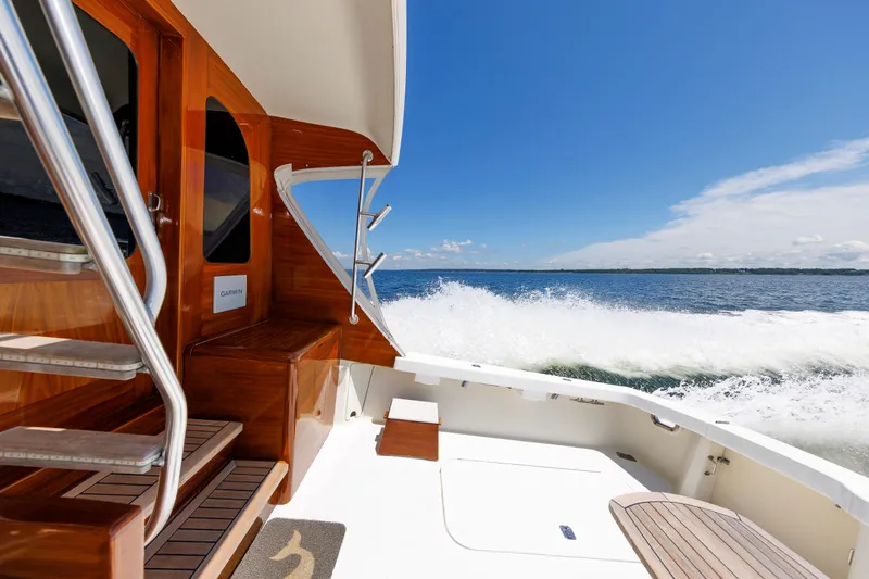 Slide: The Image of Luxury yacht cruising on open water, featuring sleek wooden interior and clear blue skies. - 29
