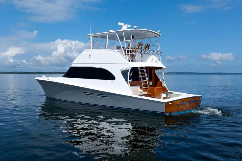 Slide: The Image of Luxury 2002 Post Convertible 56 yacht cruising on calm waters under a clear blue sky. - 3