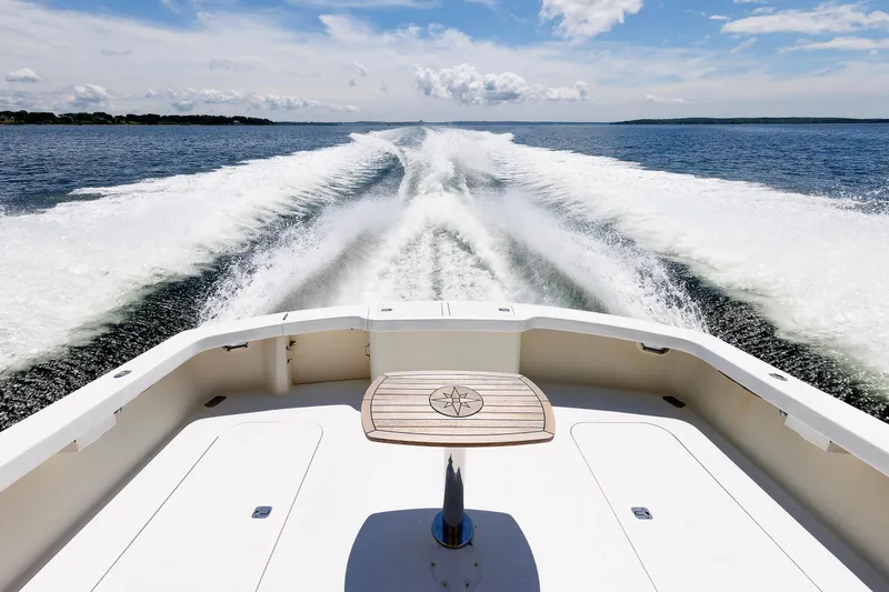 Slide: The Image of Rear view of a 2002 Post Convertible 56 boat cruising on open water. - 30