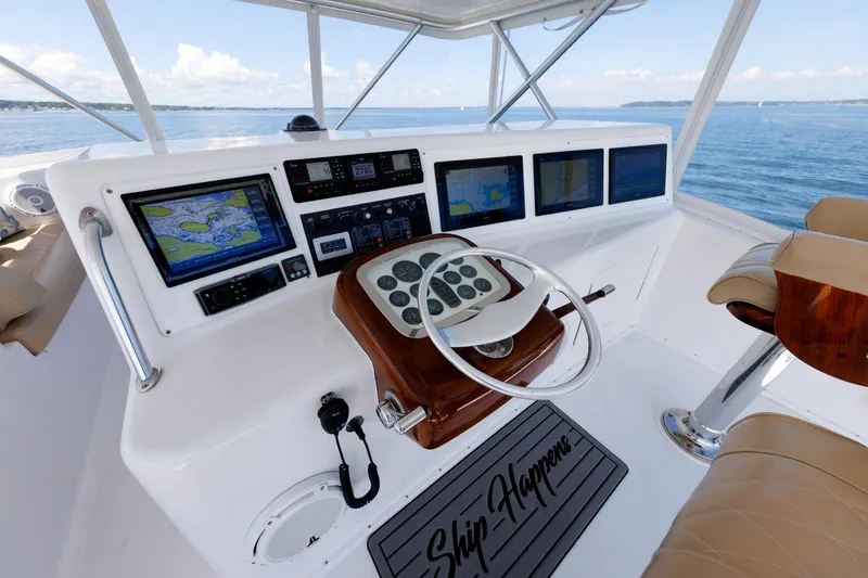 Slide: The Image of Helm of 2002 Post Convertible 56 yacht with navigation screens and leather seating. - 34