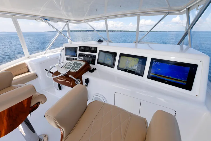 Slide: The Image of Luxurious 2002 Post Convertible 56 yacht helm with advanced navigation displays and leather seating. - 36
