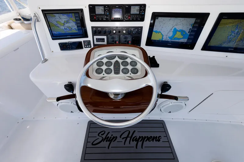 Slide: The Image of Steering wheel and navigation screens on a 2002 Post Convertible 56 yacht. - 39