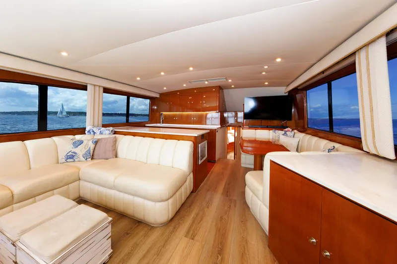 Slide: The Image of Luxurious yacht interior with cream leather seating, wooden accents, and ocean views. - 47