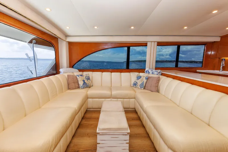 Slide: The Image of Luxurious yacht interior with cream leather seating, ocean view, and wooden accents. - 48