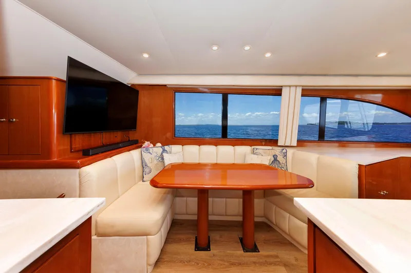 Slide: The Image of Luxurious yacht interior with ocean view, featuring a cozy dining area and modern decor. - 49