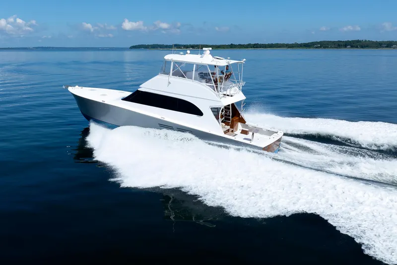 Slide: The Image of Luxurious 2002 Post Convertible 56 yacht cruising on calm blue waters. - 7