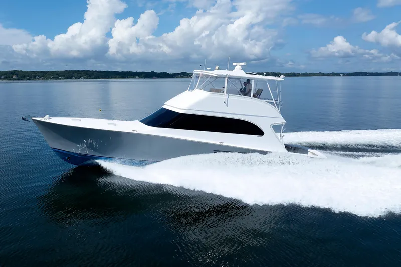 Slide: The Image of 2002 Post Convertible 56 yacht cruising on calm waters under a blue sky. - 8