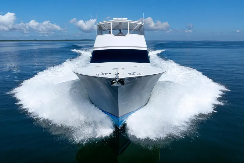 Slide: The Image of A 2002 Post Convertible 56 yacht cruising on calm blue waters. - 9