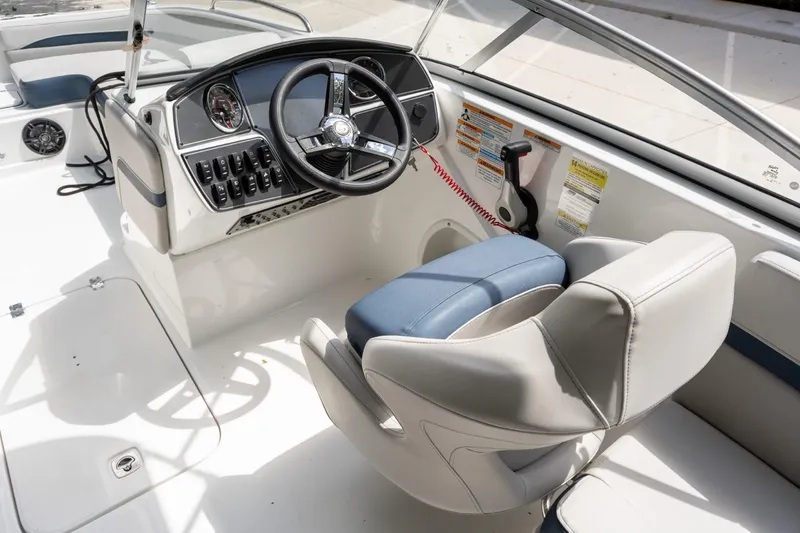 Slide: The Image of 2025 Hurricane SunDeck 217 OB boat cockpit with steering wheel and control panel. - 14