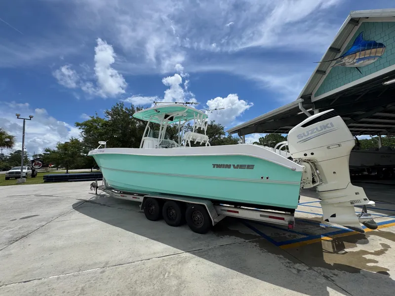 Slide: The Image of 2020 Twin Vee 310 CC GF boat on trailer with Suzuki outboard motor. - 20