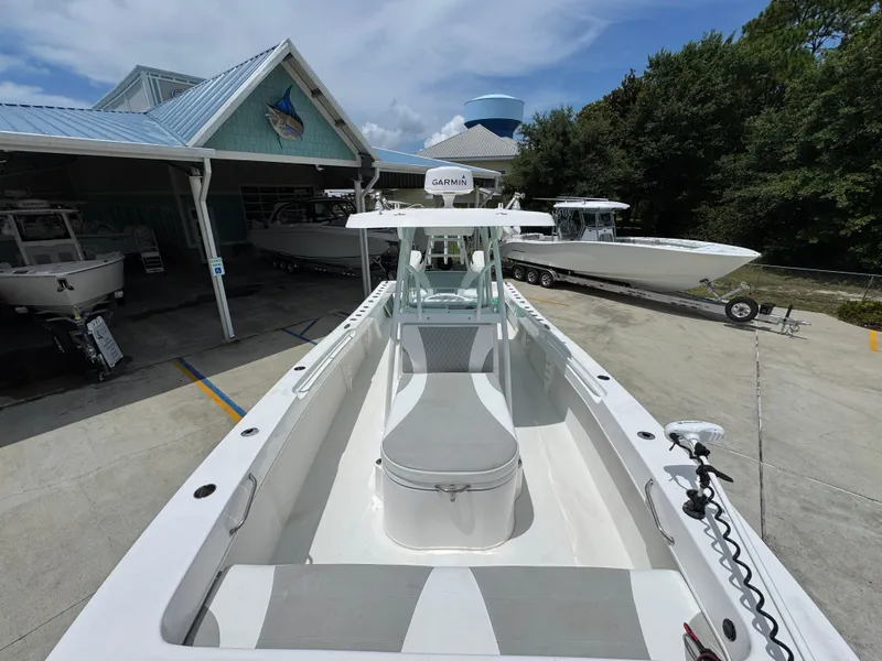 Slide: The Image of 2020 Twin Vee 310 CC GF boat docked at a marina, showcasing sleek design and spacious deck. - 26