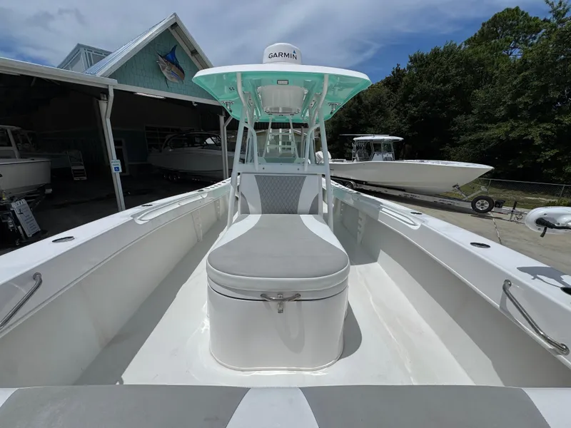 Slide: The Image of 2020 Twin Vee 310 CC GF boat with Garmin equipment, docked near a boathouse. - 27