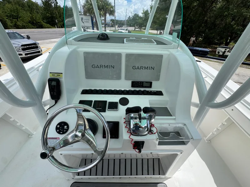 Slide: The Image of 2020 Twin Vee 310 CC GF boat dashboard with Garmin navigation system and steering wheel. - 34