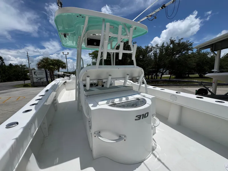 Slide: The Image of 2020 Twin Vee 310 CC GF boat, white deck, under clear blue sky. - 37