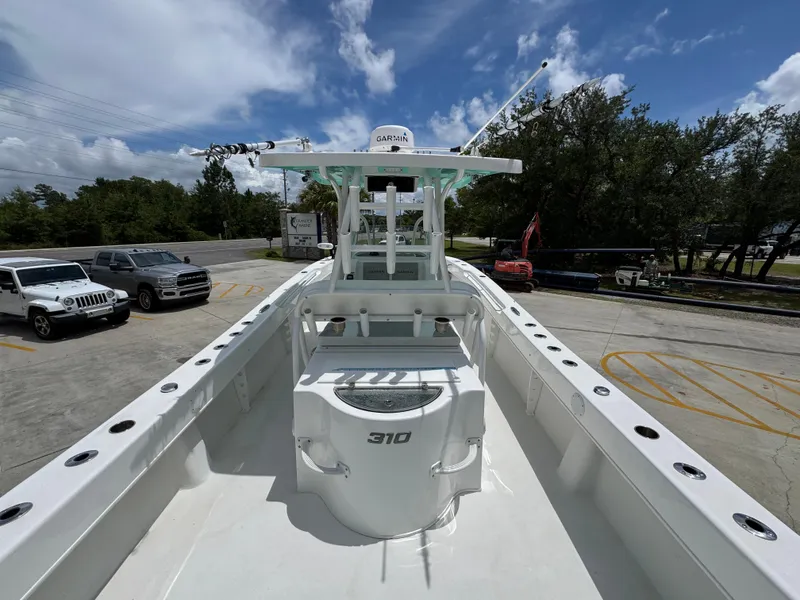 Slide: The Image of 2020 Twin Vee 310 CC GF boat with Garmin equipment, parked outdoors under a blue sky. - 38