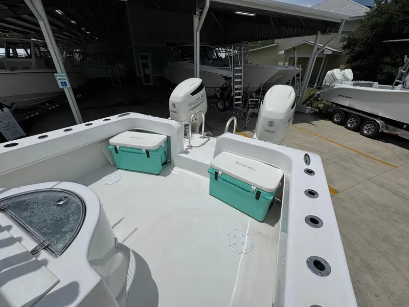 Slide: The Image of 2020 Twin Vee 310 CC GF boat with Suzuki engines and Engel coolers in a marina. - 39