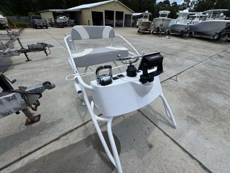 Slide: The Image of 2020 Twin Vee 310 CC GF boat console with Garmin equipment in a boatyard. - 42