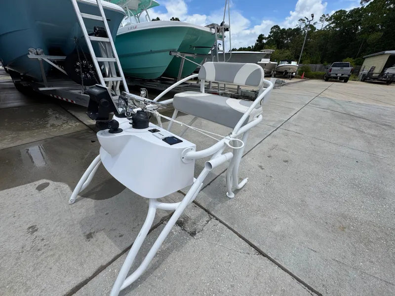 Slide: The Image of 2020 Twin Vee 310 CC GF boat console on a concrete surface, surrounded by other boats. - 44